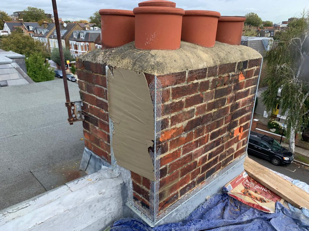 Chimney stack repaired and rendered with fresh lead flashing